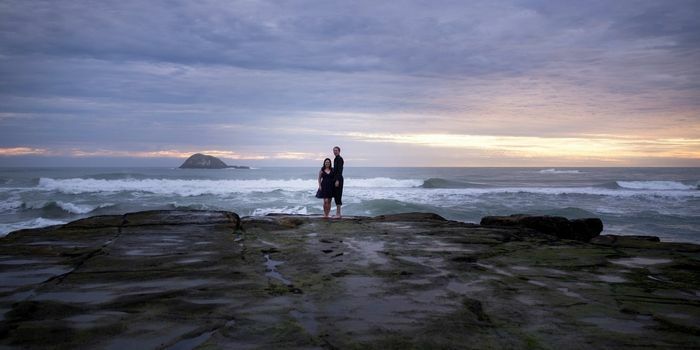 Roimata & Tristan standing on rocks at Muriwai Auckland
