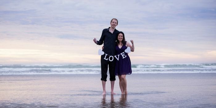 Roimata & Tristan holding a love sign at Muriwai Beach in West Auckland